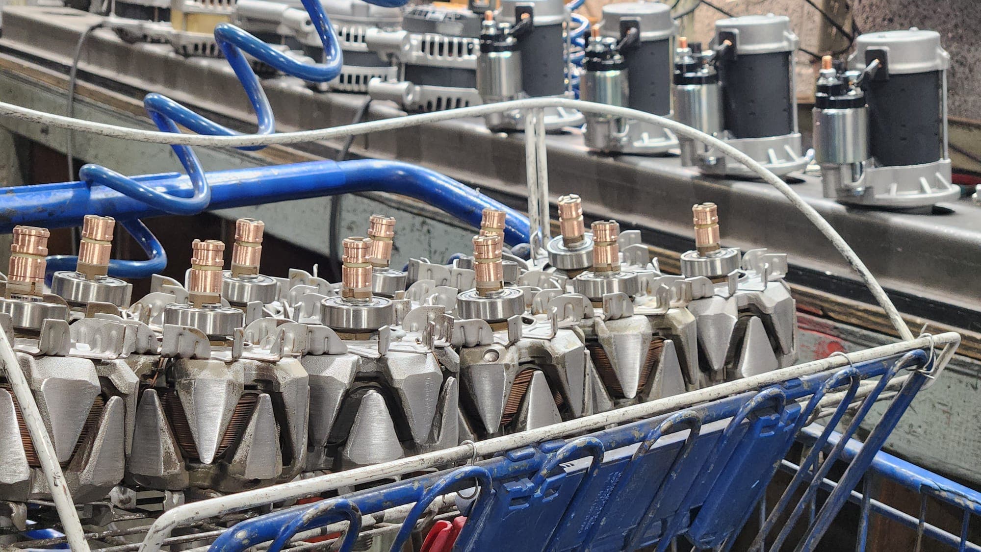 Rebuilt starters with new solenoids on the workbench at Manfield Rebuilders in Detroit