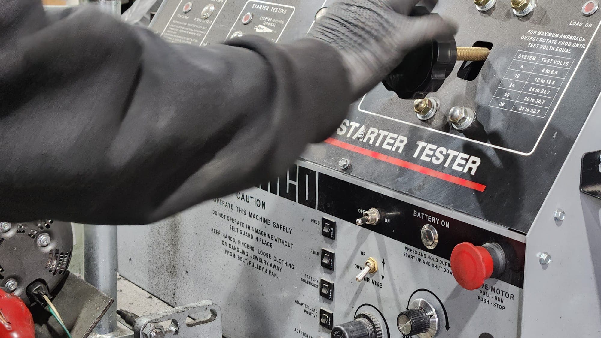 Technician bench-testing a rebuilt starter motor at Manfield Rebuilders
